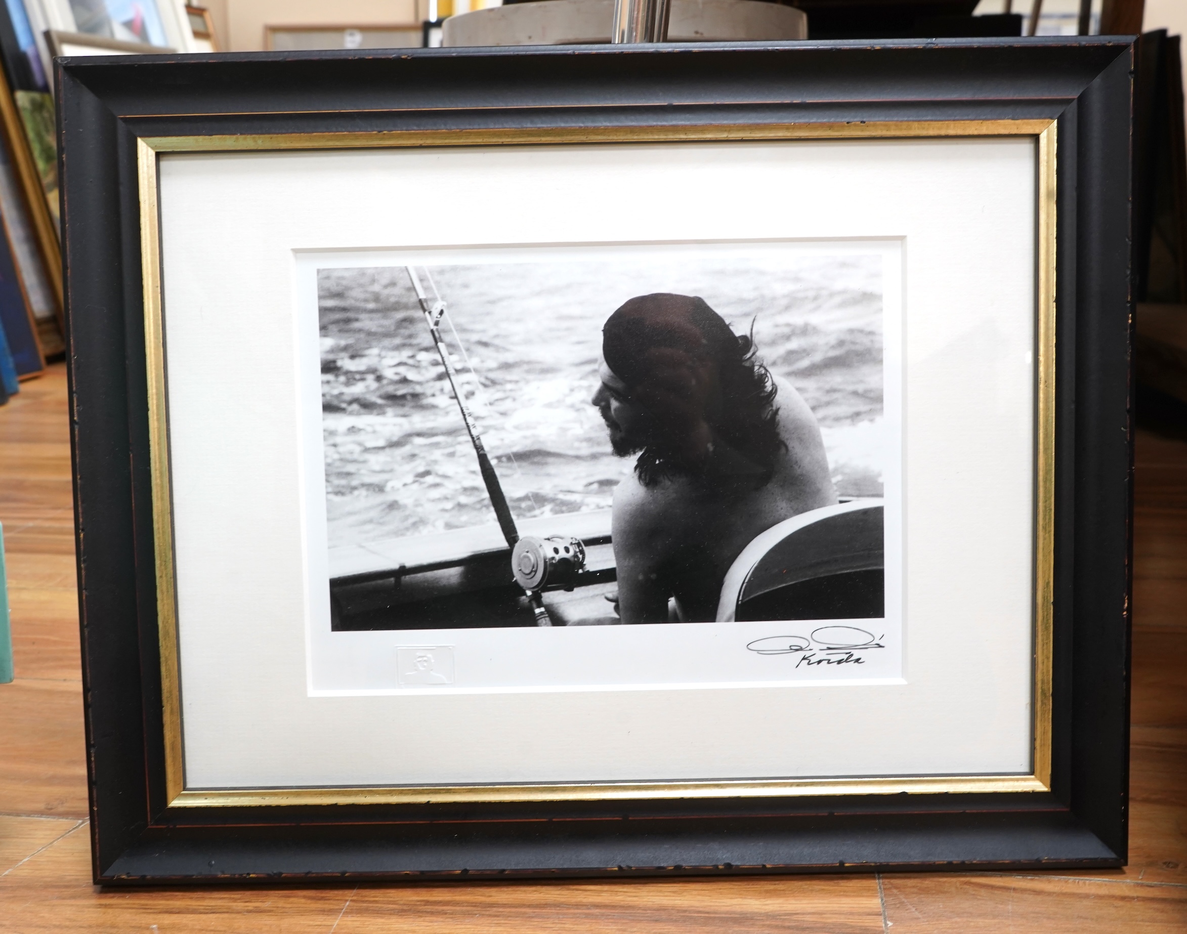 After Alberto Korda (1928-2001), ‘Che Guevara fishing’, stamped, facsimile signature, gelatin silver print, 20 x 26cm
